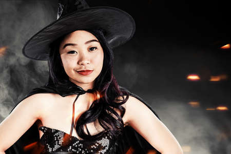 Asian witch woman with a hat standing with a black background