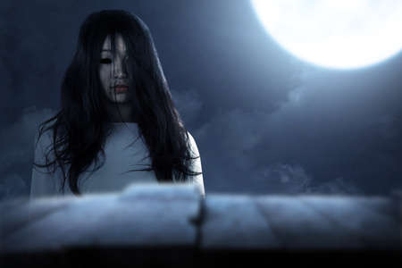 Scary ghost woman standing with night scene background. Halloween conceptの写真素材