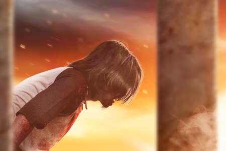 Scary zombie with blood and wound on his body standing with dramatic backgroundの写真素材
