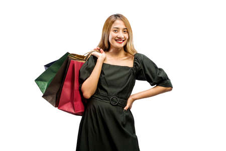 Asian woman carrying shopping bags isolated over white background