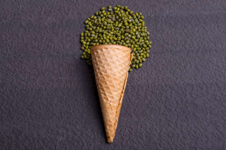 Ice cream cone with mung beans on black backgroundの写真素材
