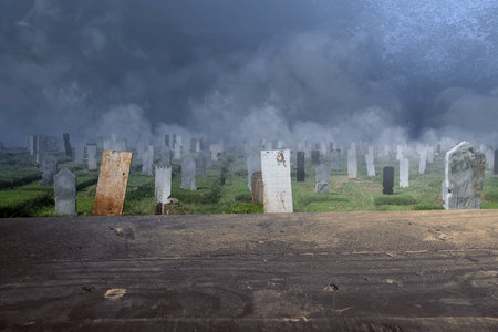 Wooden table with tombstones on the graveyard with night scene background. Halloween conceptの写真素材