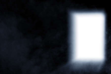 Opened door with white light on the dark roomの写真素材