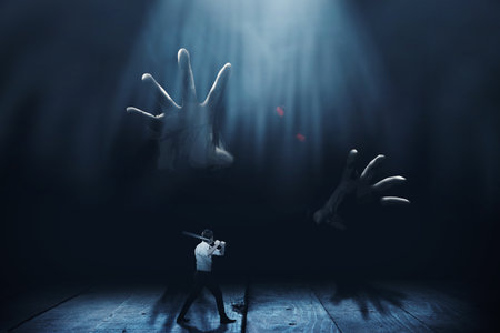 Asian man standing with a baseball bat in his hand ready to attack giant zombie with dark backgroundの写真素材