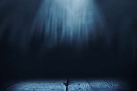 Wooden table with dark backgroundの写真素材