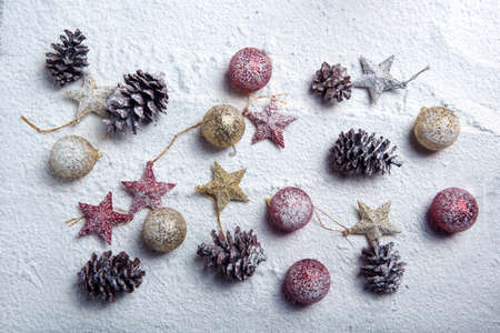Pinecone, Christmas ball, and star on the snow. Christmas decoration