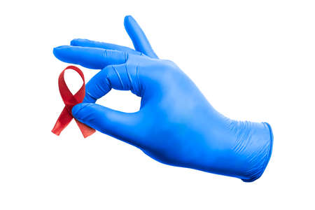 Red ribbon and medical glove with white background. Hiv Aids ribbon awareness