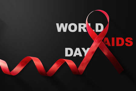 Red ribbon with a black background. Hiv Aids ribbon awareness