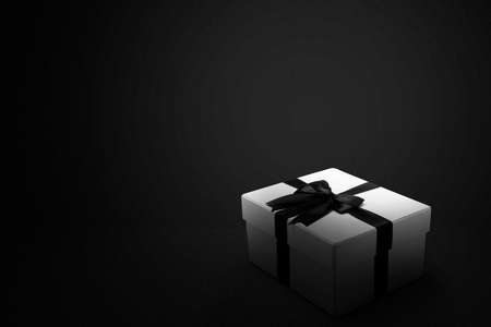White gift box with a black ribbon with a black background. Black Friday concept
