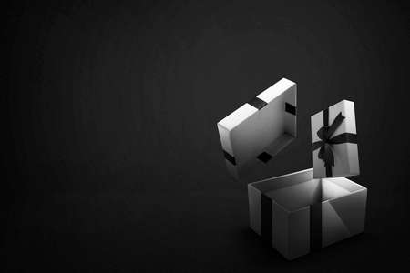 Opened a white gift box with a black ribbon with a black background. Black Friday conceptの写真素材