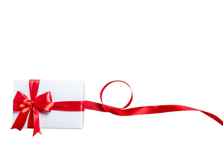 White gift box with red ribbon isolated over white backgroundの写真素材