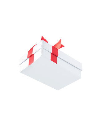 White gift box with red ribbon isolated over white background