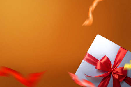White gift box with red ribbon with a colored background. Boxing Dayの写真素材