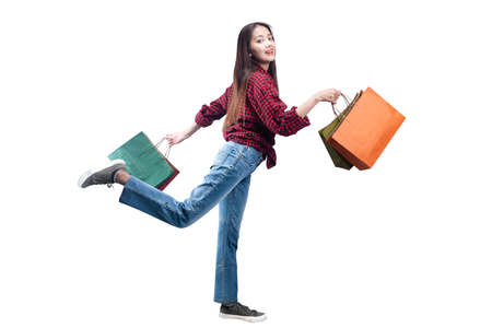 Asian woman carrying shopping bags isolated over white backgroundの写真素材