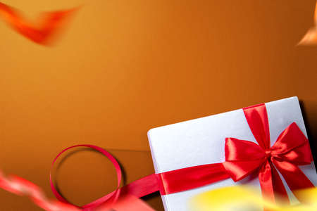 White gift box with red ribbon with a colored background. Boxing Dayの写真素材
