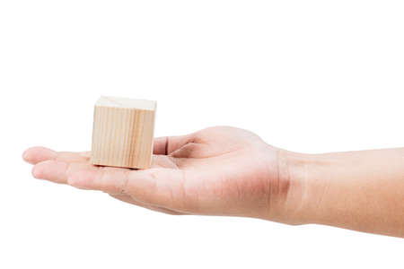 Hand holding wooden block toy isolated over white backgroundの写真素材
