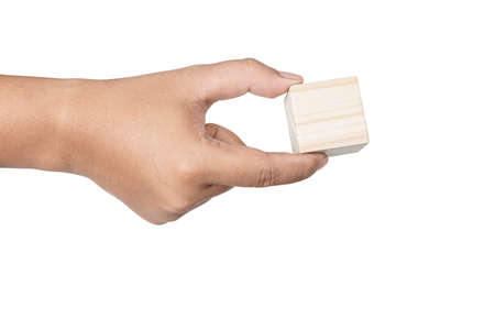 Hand holding wooden block toy isolated over white backgroundの写真素材