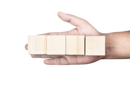 Hand holding wooden block toy isolated over white backgroundの写真素材