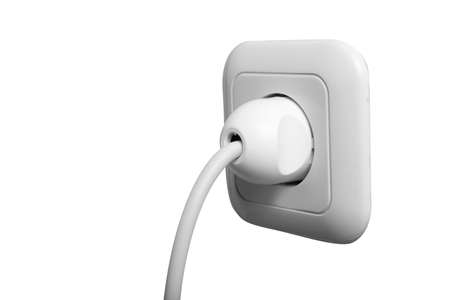 Electric plug into a white power socket isolated over white background