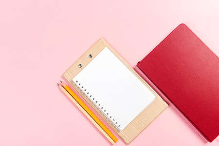 Note book with a pen with colored backgroundの写真素材