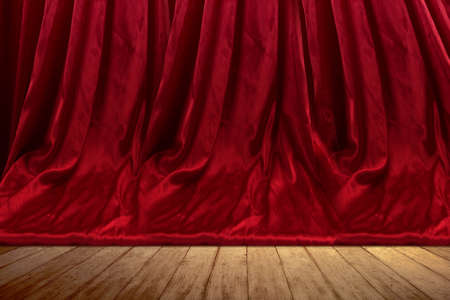 Closeup view of the red curtain with wooden floorの写真素材