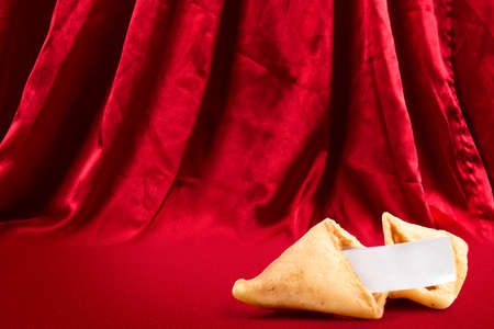 Fortune cookies with an empty quote with red curtain background. Happy Chinese New Yearの写真素材