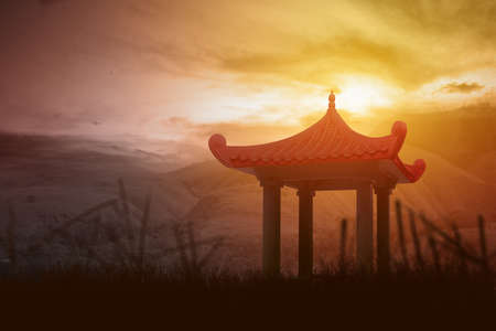 Chinese gazebo building on the hill with dramatic sky backgroundの写真素材