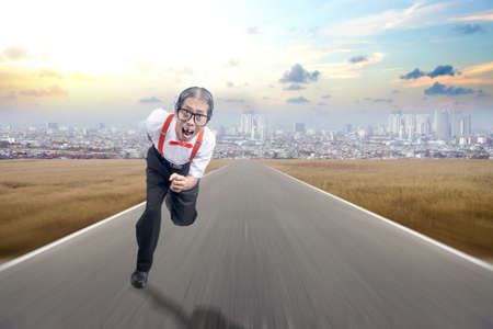 Asian nerd with ugly face running on the street with cityscapes background
