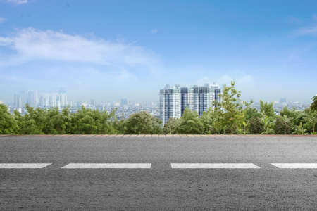 Asphalt road with modern building and skyscrapers on the midtownの写真素材