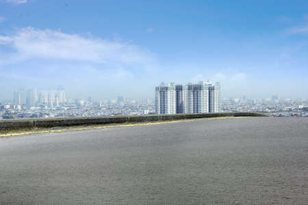 Asphalt road with modern building and skyscrapers on the midtown