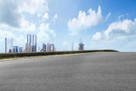 Asphalt road with modern building and skyscrapers on the midtownの写真素材