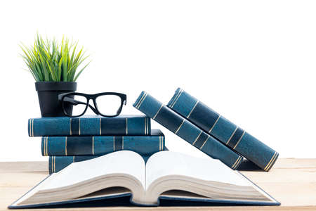 Closeup view of the opened book on wooden table with white background