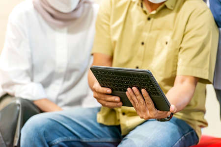 Businessman with a tablet discussing business in the workplace