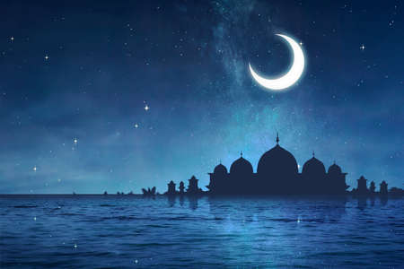 Silhouette of a mosque with lake and night scene backgroundの写真素材