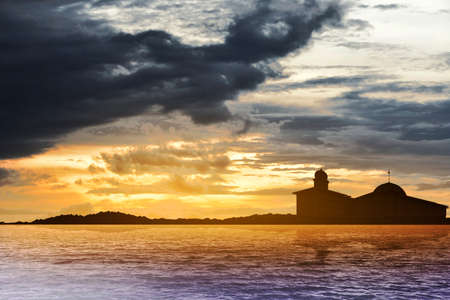 Silhouette of a mosque with lake and dramatic scene backgroundの写真素材