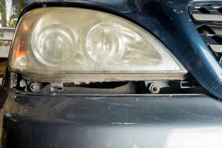 Closeup view of the dirty headlamp of a carの写真素材