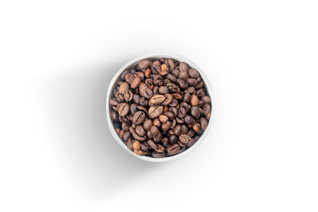 Cup with coffee beans isolated over white background
