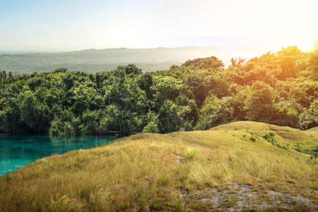 Green hills with landscape view with a sunlight backgroundの写真素材