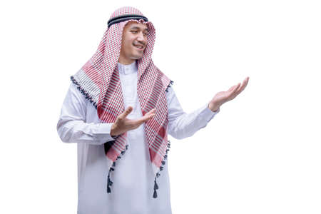 Arab man wearing keffiyeh showing something on his hand isolated over white backgroundの写真素材