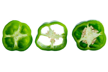 Sliced green peppers isolated over white backgroundの写真素材