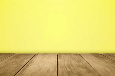 Wooden table with colored wall backgroundの写真素材