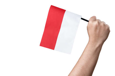 Human hand holding an Indonesian flag isolated over white backgroundの写真素材