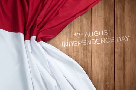 Wooden board with Indonesian independence day message with a red and white flag background. Indonesian independence dayの写真素材