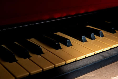 Closeup view of an electronic piano keyboard with dark backgroundの写真素材