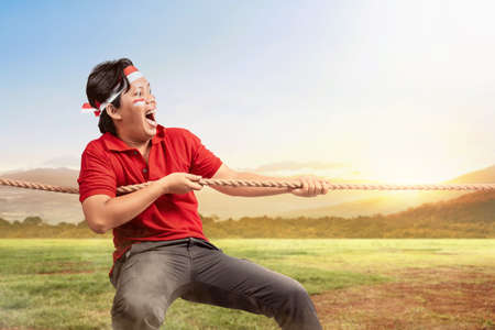 Indonesian men celebrate Indonesian independence day on 17 August with the tug of war contest....