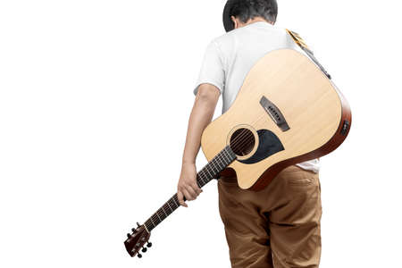 Rear view of man carrying guitar isolated over white backgroundの写真素材