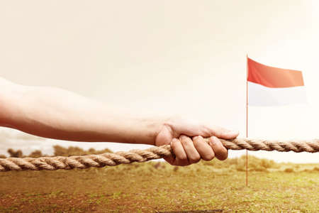 Indonesian men celebrate Indonesian independence day on 17 August with the tug of war contest. Indonesian independence dayの写真素材