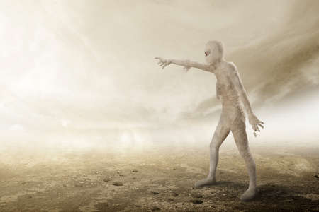 Mummy walking with claw hands with the foggy background. Halloween conceptの写真素材