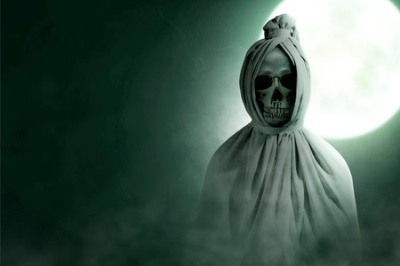 Pocong is covered with a white linen shroud standing with full moon background. Halloween conceptの写真素材