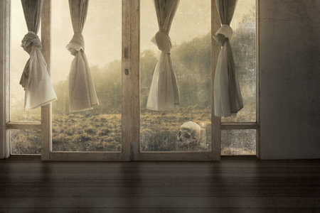 Windows with the curtain in an abandoned house with a dramatic backgroundの写真素材
